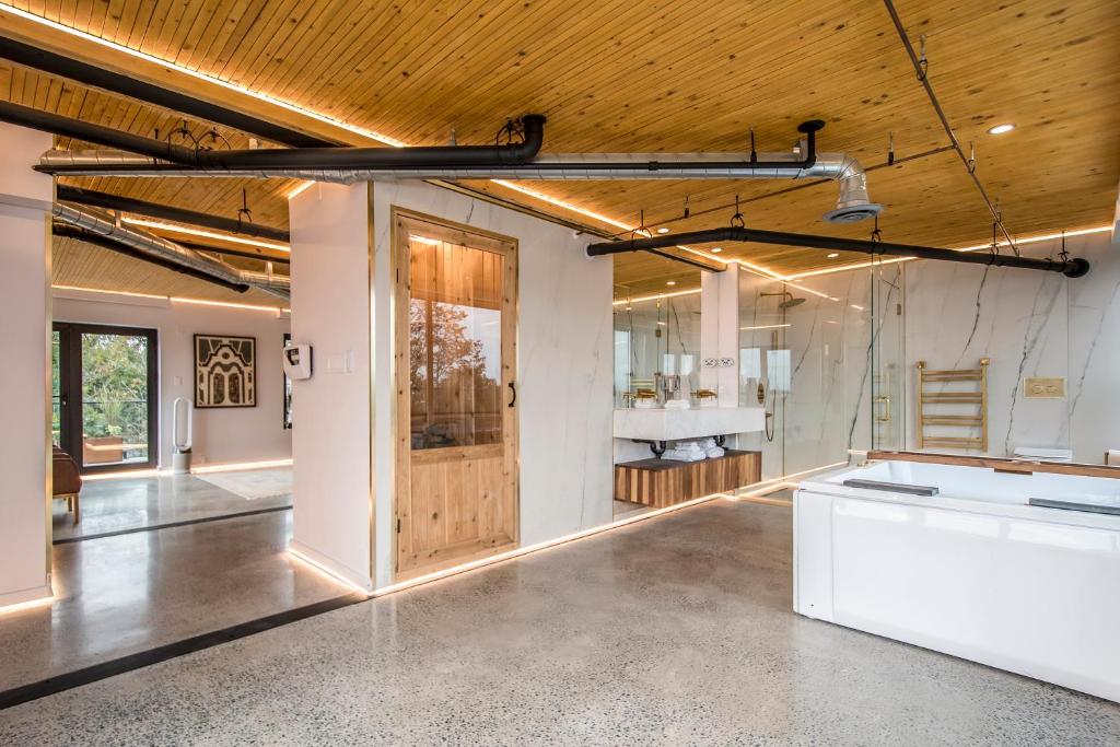 a large room with a wooden ceiling and a kitchen at Penthouse - Spa-Inspired Guest Suite, Halifax Rooftop Home in Halifax