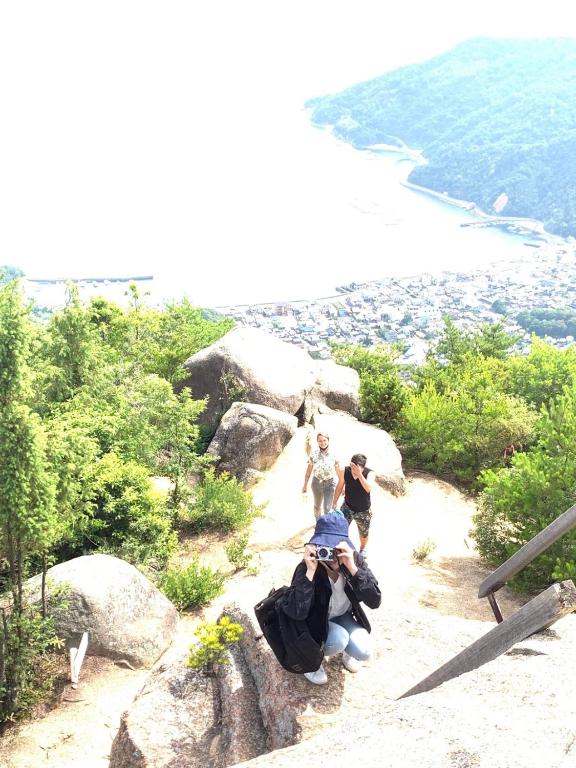 a group of people standing on top of a mountain at Guesthouse SETOUCHI LIFE in Kure