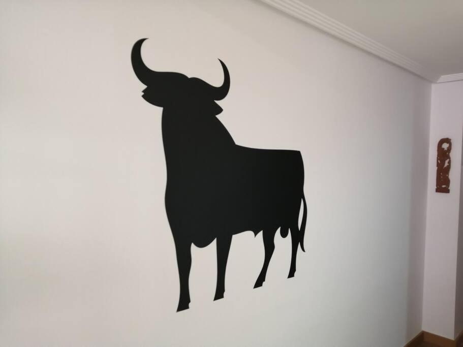 a silhouette of a bull on a wall at Alicante airport and beach in El Alted
