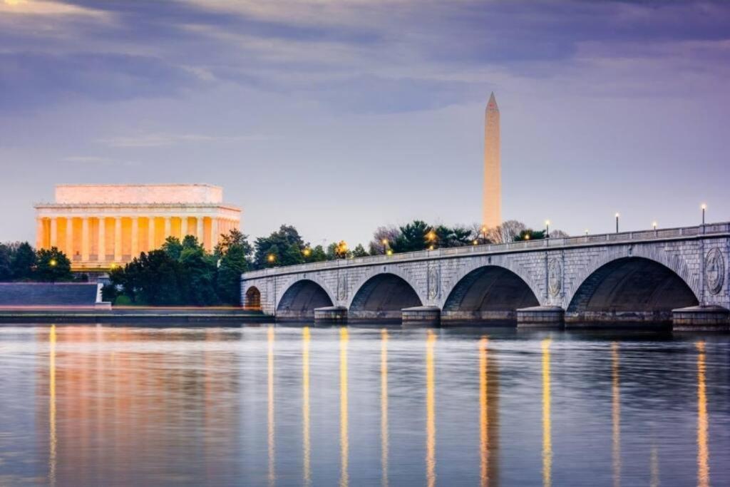 a bridge over the water with a building in the background at Free Parking Near DC, National Mall, MGM & Airport in Arlington