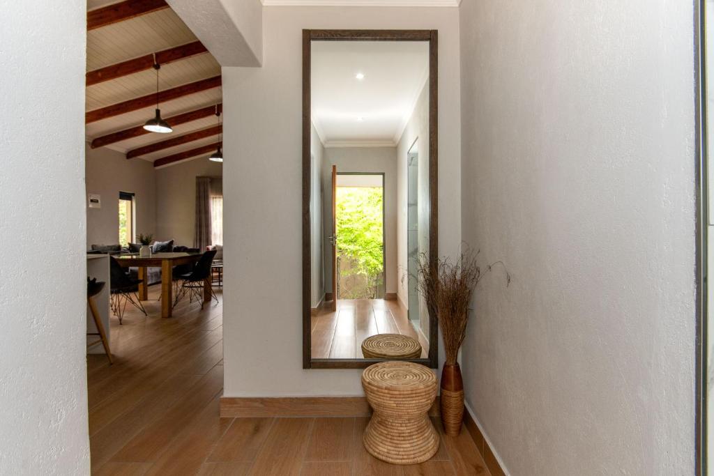 a hallway of a home with a mirror and a table at Utopia on the Rock1 in Nelspruit