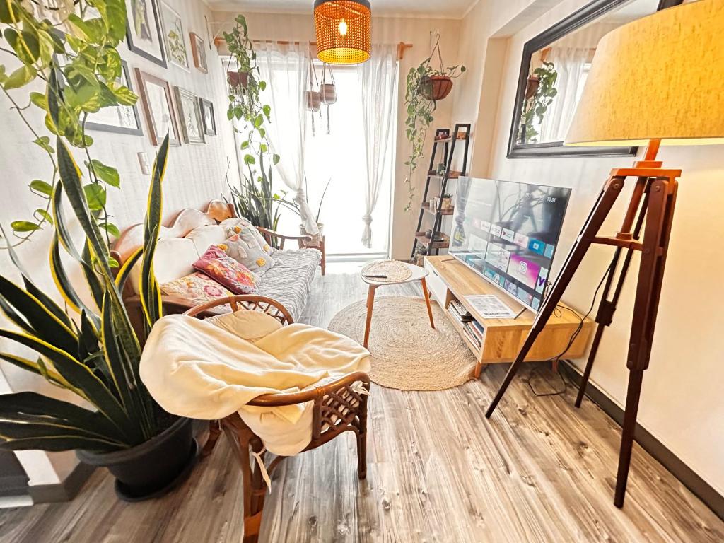 departamento encantador céntrico con balcon في ليما: غرفة معيشة مع أريكة وتلفزيون