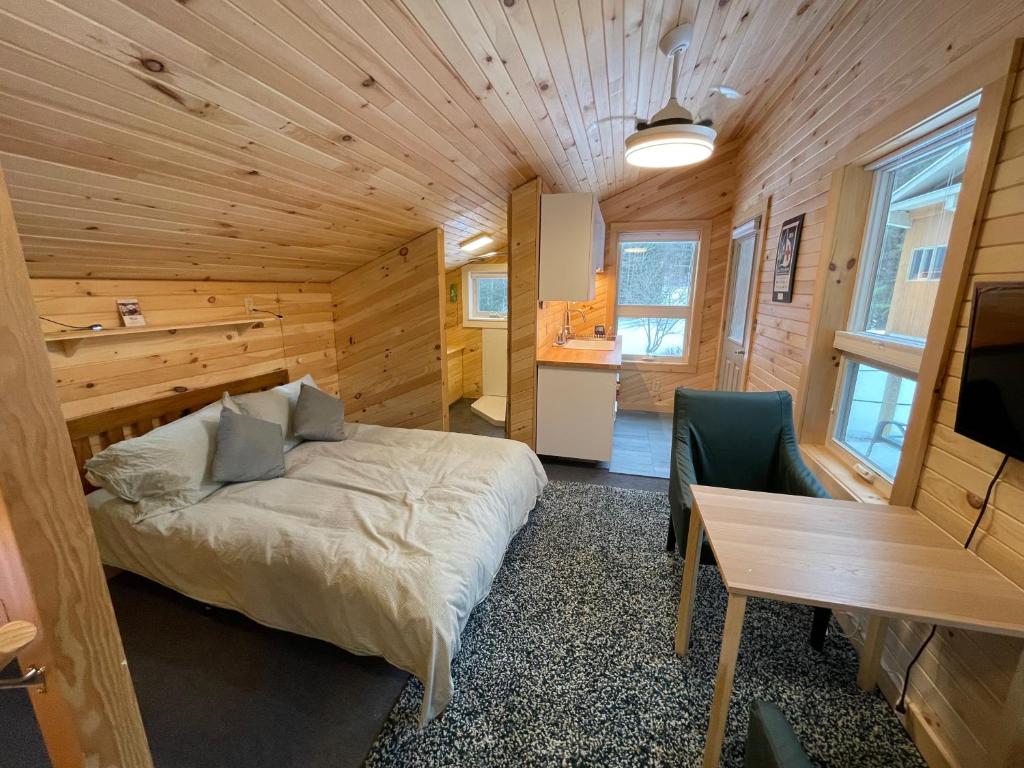 a bedroom with a bed and a desk in a room at Crossett Hill Lodge in Duxbury