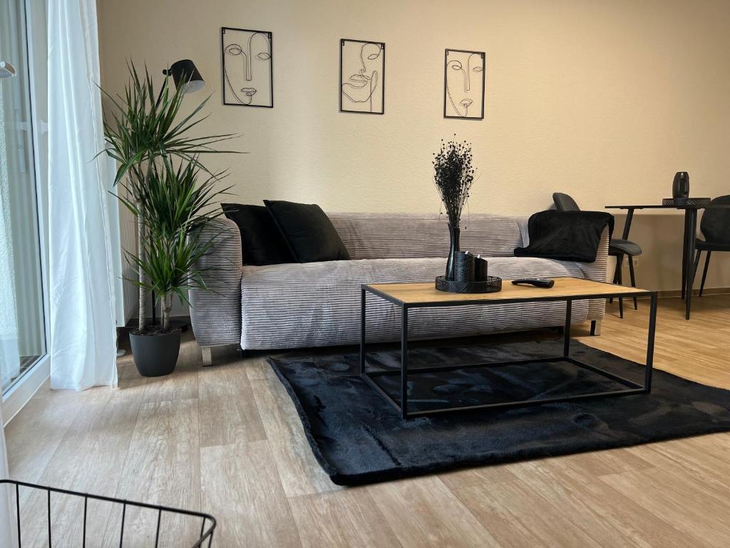 a living room with a couch and a coffee table at Charming Homes - Studio 11 in Wolfsburg