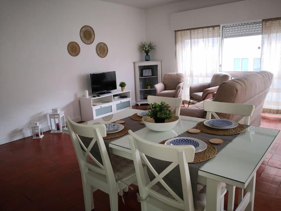 a living room with a table and chairs at Beach and Surf Lovers in Costa da Caparica