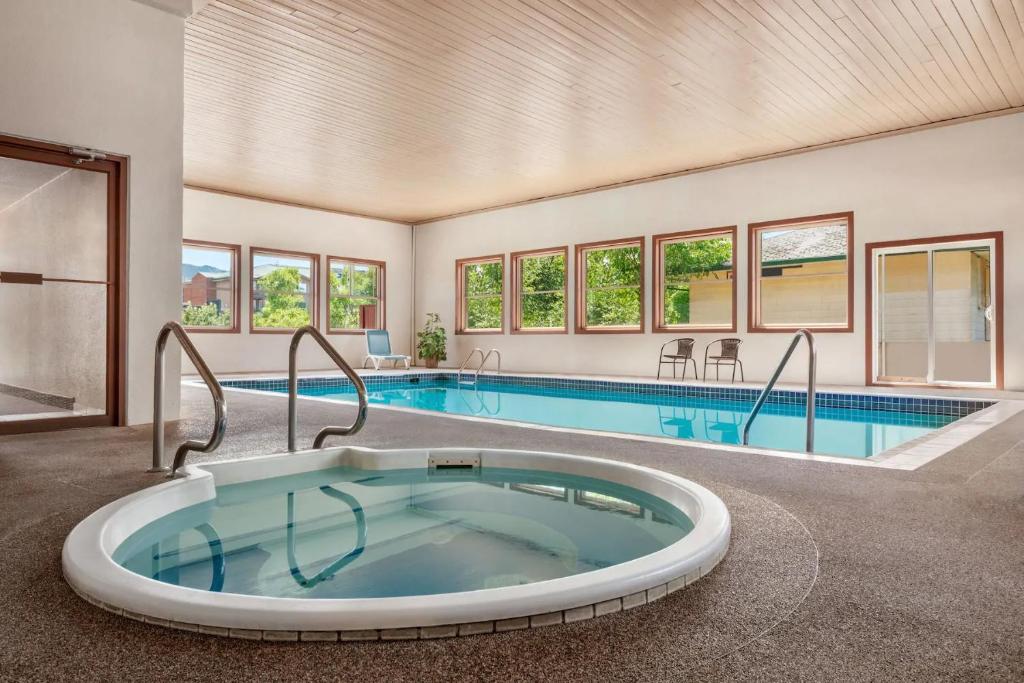 a large swimming pool with a large tub in a house at Quality Inn & Suites in Vernon