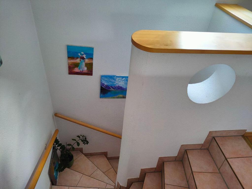 a staircase in a house with two pictures on the wall at Neuenhagen Haven in Neuenhagen