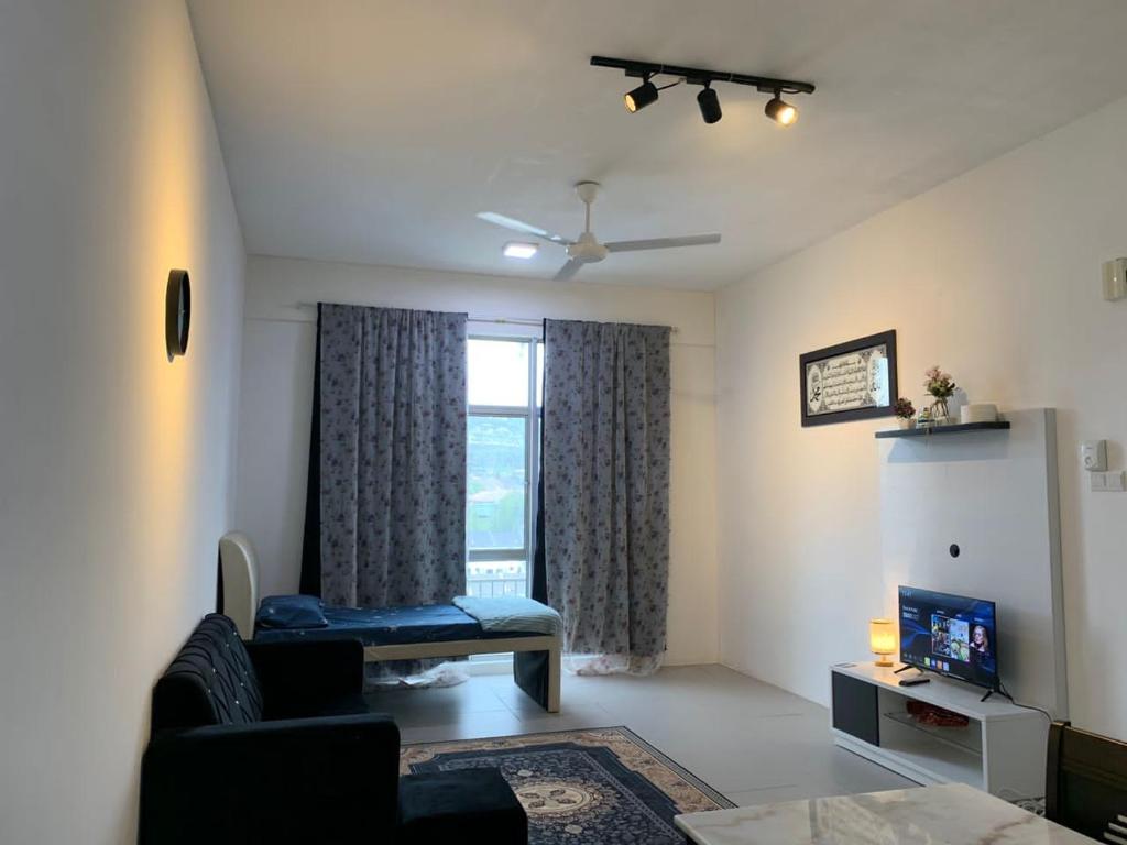 a living room with a couch and a window at Alliv NSF Studio & 1 Bedroom Apartment Stay in Brinchang