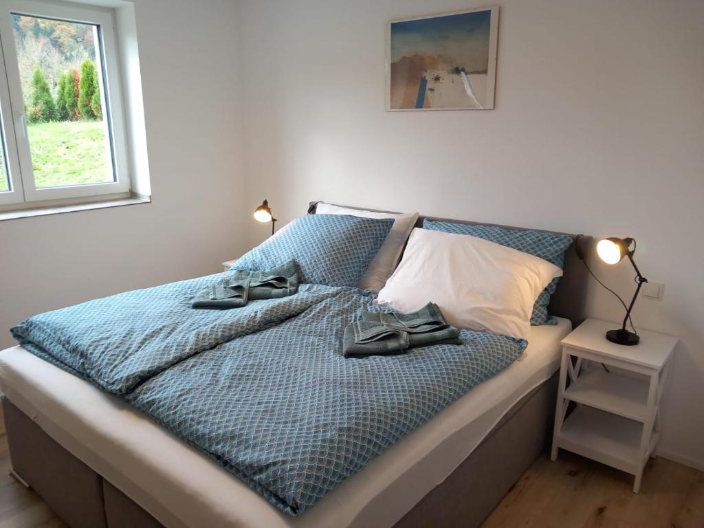 a bed with two pairs of shoes sitting on it at Feriennest Ossiachersee in Bodensdorf