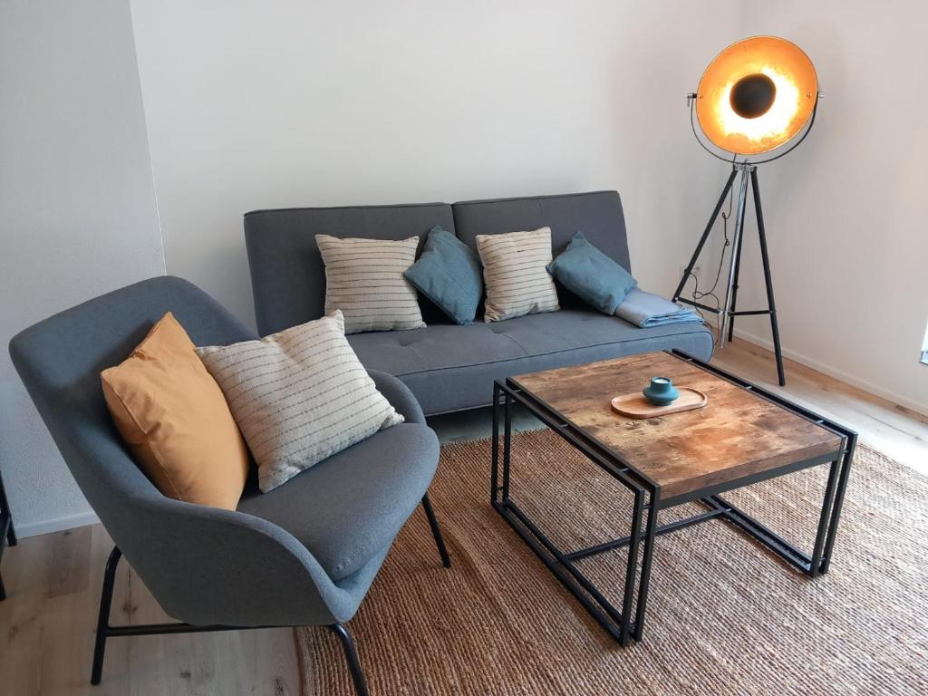 a living room with a blue couch and a coffee table at Feriennest Ossiachersee in Bodensdorf