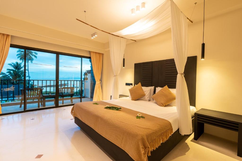 a bedroom with a bed with a view of the ocean at Samaya Wellness Resort in Lamai