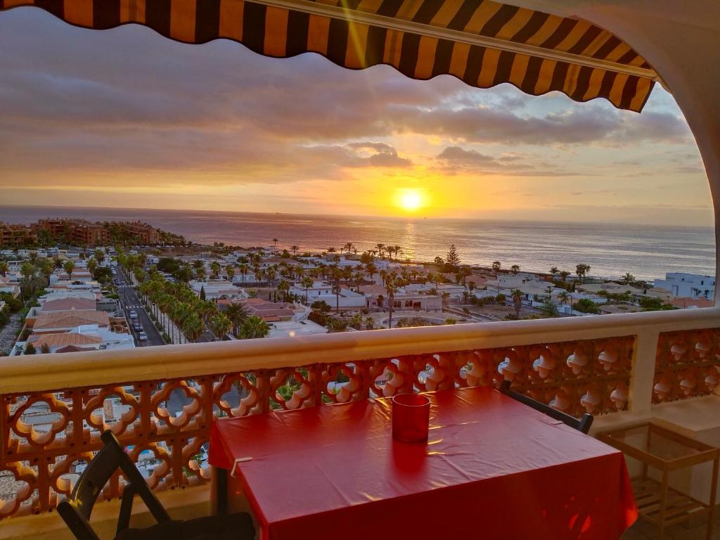 a table on a balcony with a view of the beach at Palm-Mar Appartement Celeste 250m de l'ocean vue mer panoramique in Palm-Mar