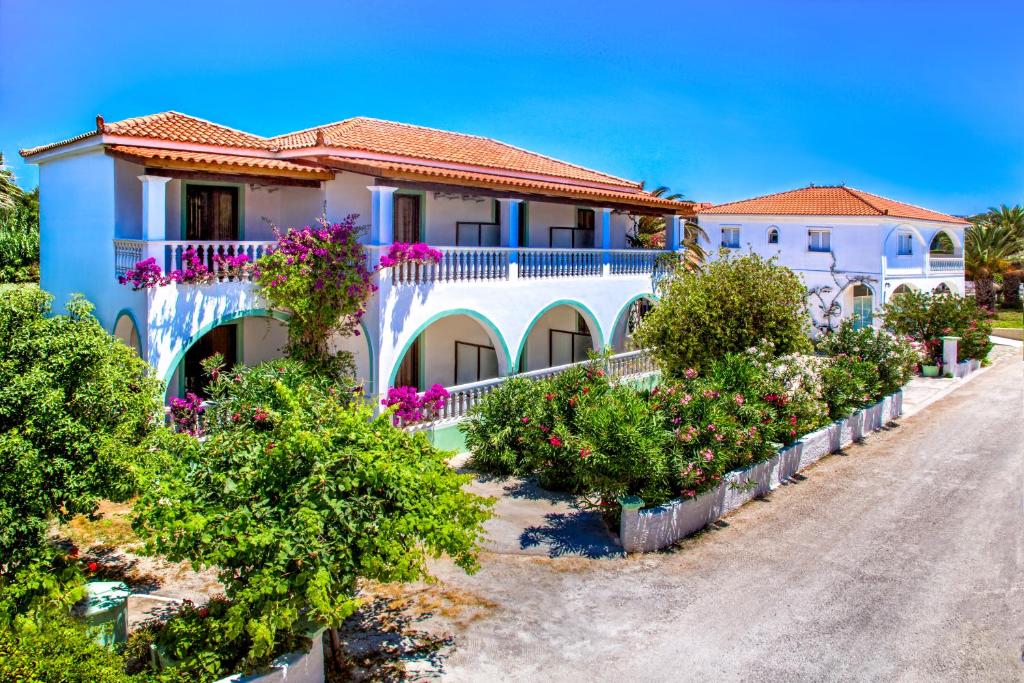 a house with flowers on the side of a road at Romantic Studios in Lithakia