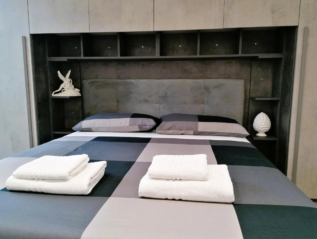a bedroom with two beds with white pillows at Golf Club Marco Simone in Marco Simone