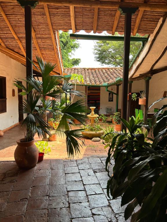a courtyard with plants and a fountain in a building at Nacuma Garden Hostel - Casa Nacuma in Barichara
