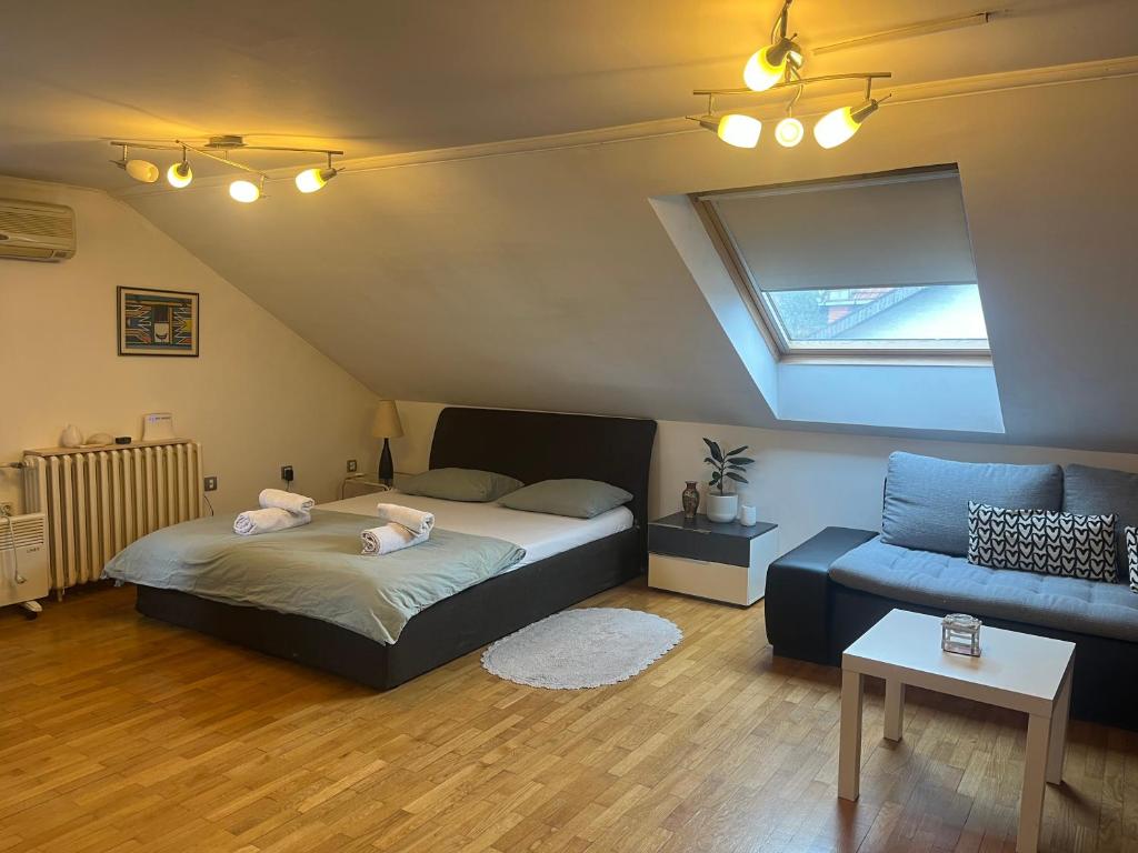 een slaapkamer met een bed en een bank bij istanbul apartment 4 in Belgrado