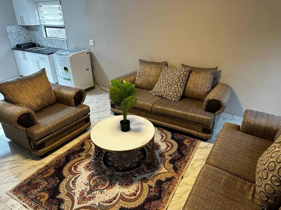 a living room with two couches and a table at Haven House in East London