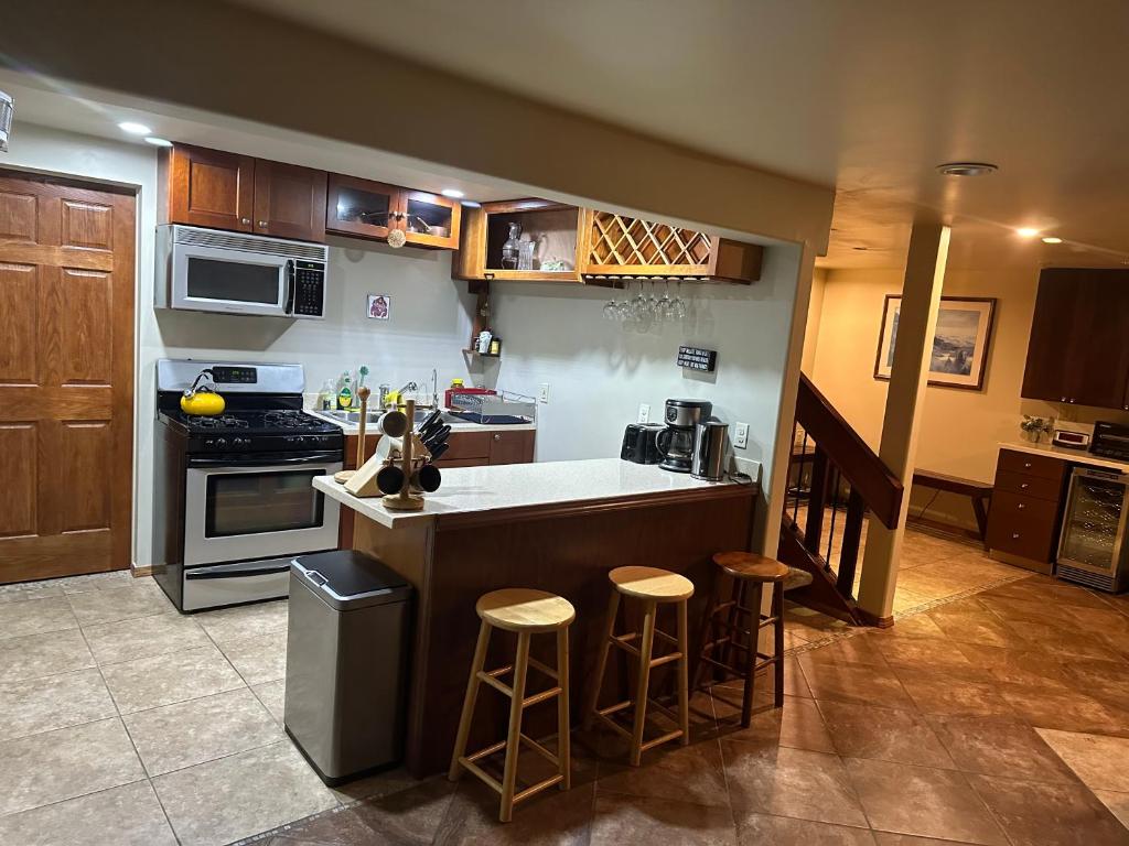 a kitchen with a counter and some bar stools at Forget me not Home in Anchorage