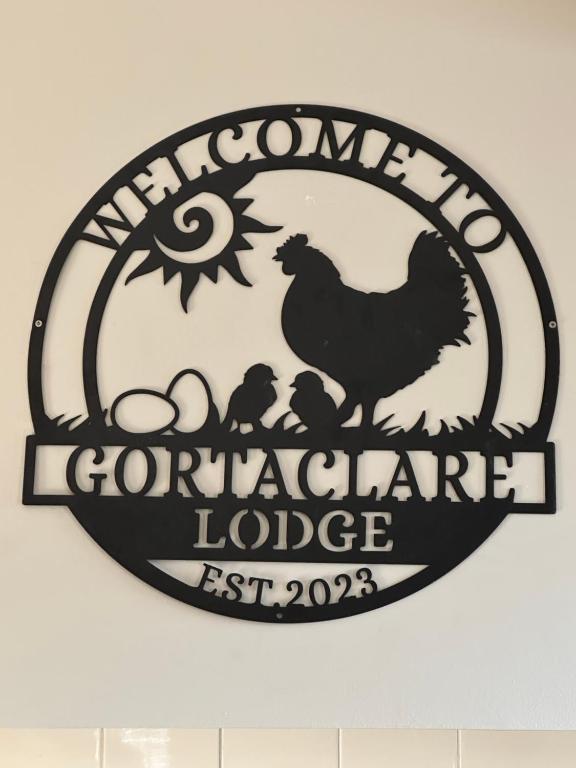 a sign with a chicken and eggs on a wall at Gortaclare Lodge 