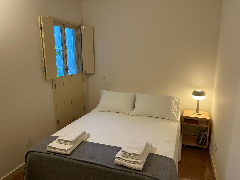 a bedroom with a bed with two towels on it at Porto Siza Apartment in Porto