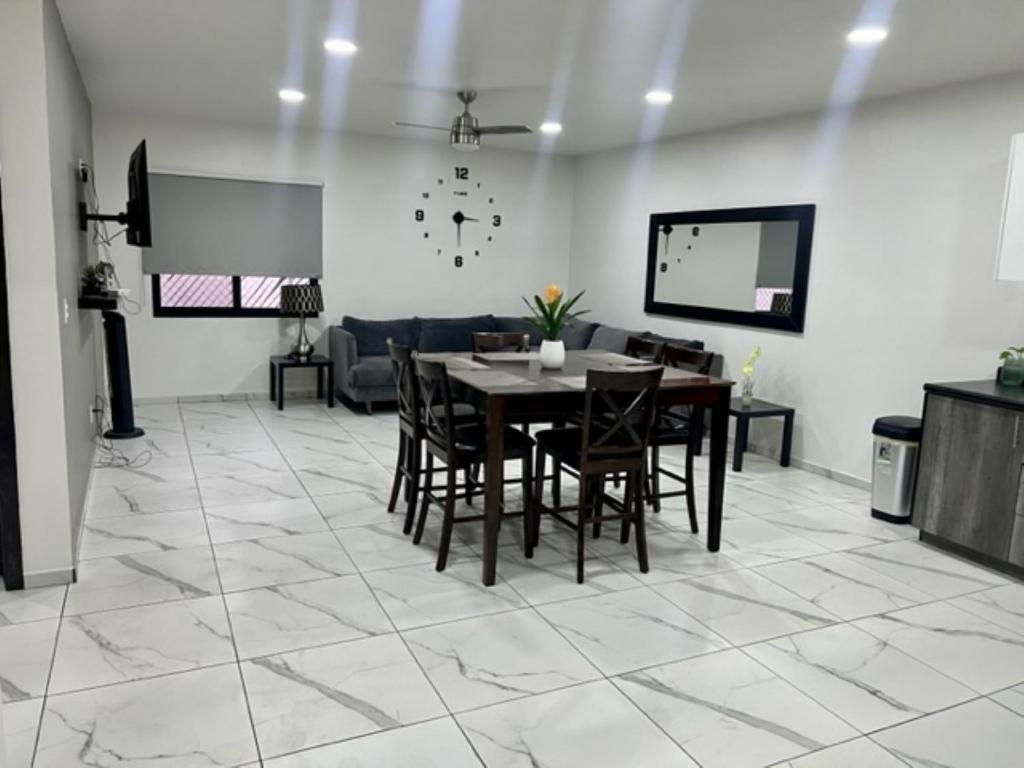 a dining room with a table and chairs on a tile floor at DEPARTAMENTOS ARTICULO 123 - departamento #2 in Tijuana