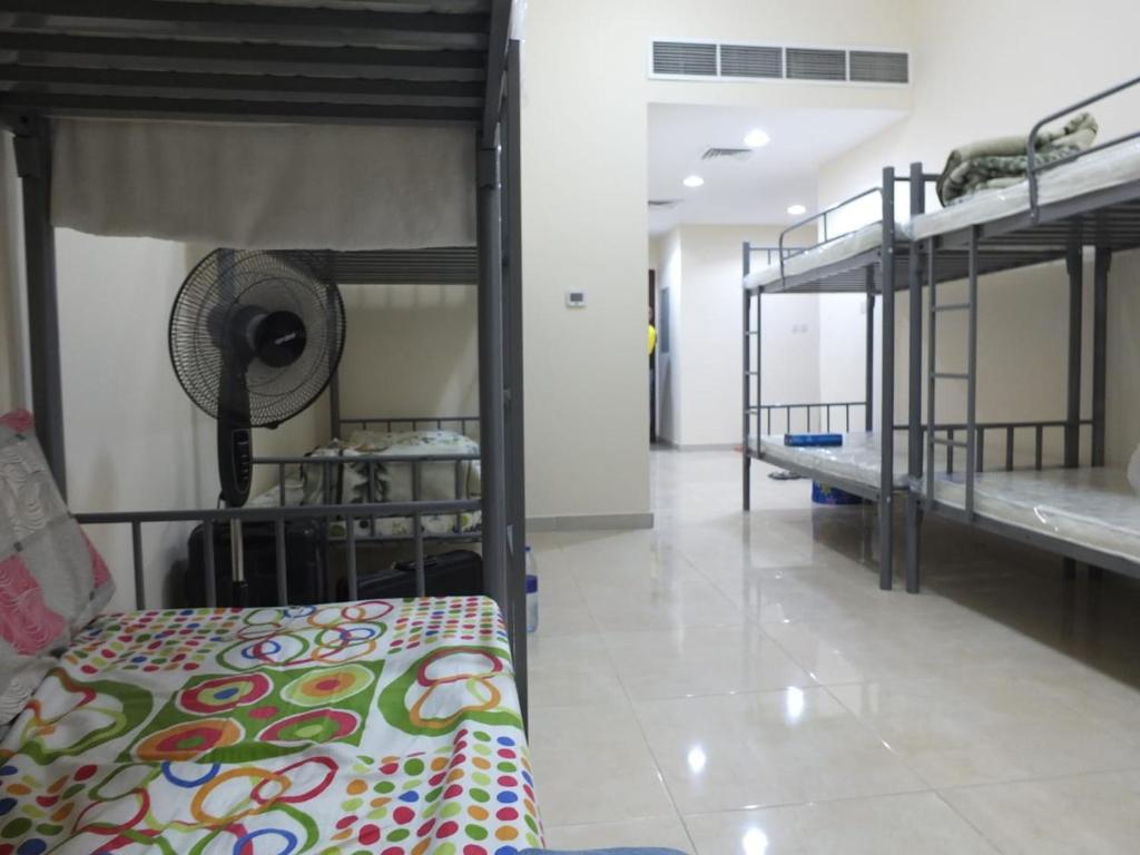 a room with three bunk beds in a dorm at DUBEDZ in Dubai