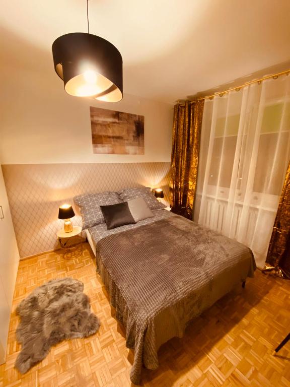 a bedroom with a large bed in a room at ClickTheFlat Wokalna Apart Rooms in Warsaw