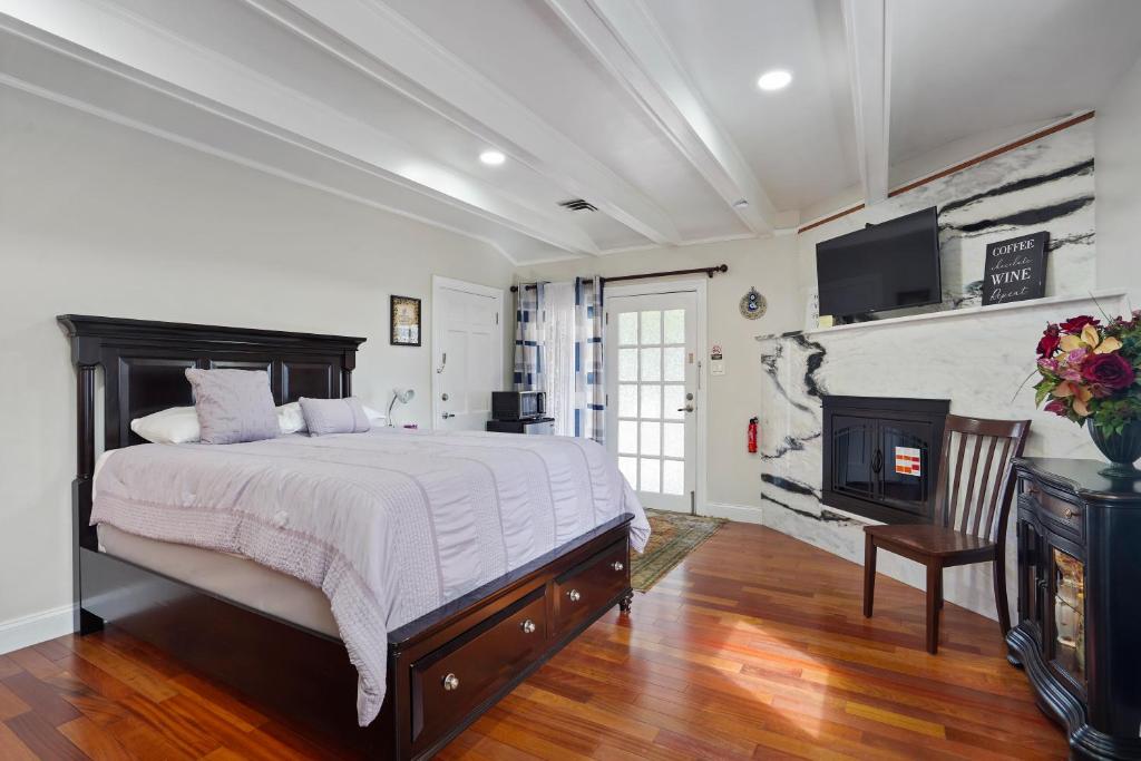 a bedroom with a large bed and a fireplace at Harbor Riverside Property 1 in Fort Washington