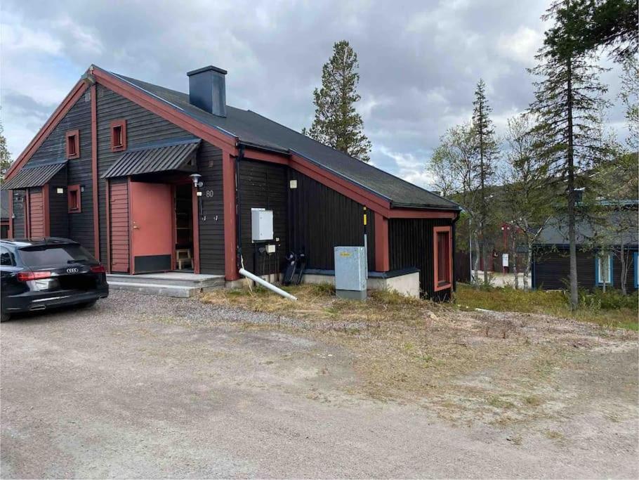 a house with a car parked in front of it at Välplanerad ski-in/out stuga med bastu in Gällivare