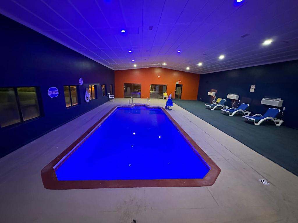 a large swimming pool in a gym with blue lighting at Super 8 by Wyndham Tucumcari in Tucumcari