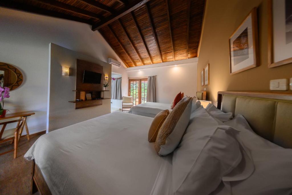 Postel nebo postele na pokoji v ubytování Alta Gracia Parque Hotel