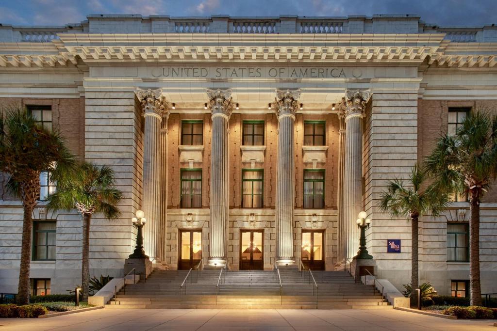 a united states of america building with palm trees in front at Le Méridien Tampa, The Courthouse in Tampa