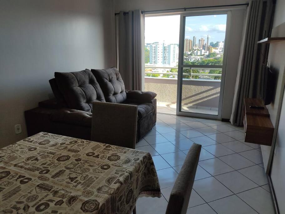 a living room with a couch and a table at Apartamento com mobília nova 302 in Francisco Beltrão