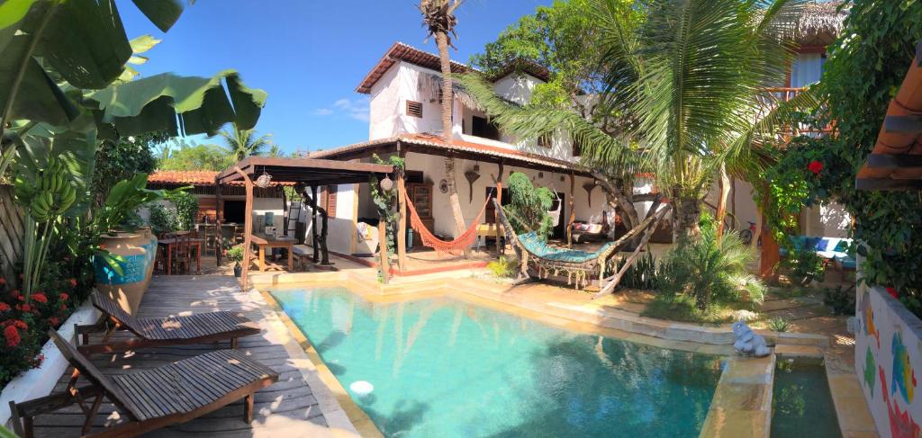 ein Haus mit einem Pool und einem Spielplatz in der Unterkunft Villa Cajuiero Inn in Prea