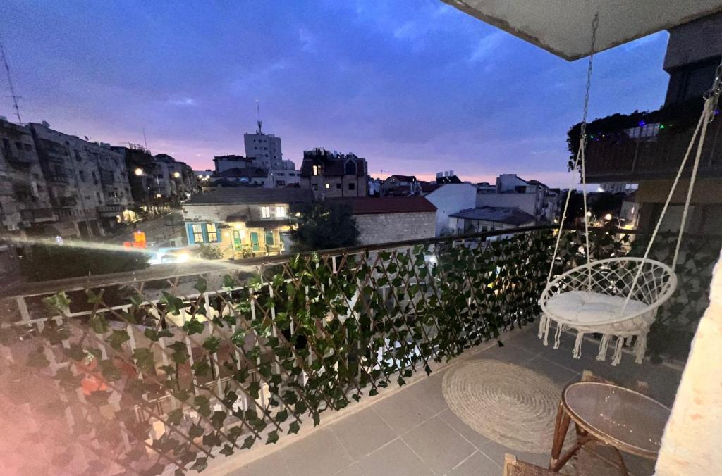 a balcony with a view of a city at night at The best location in Jerusalem 1 in Jerusalem