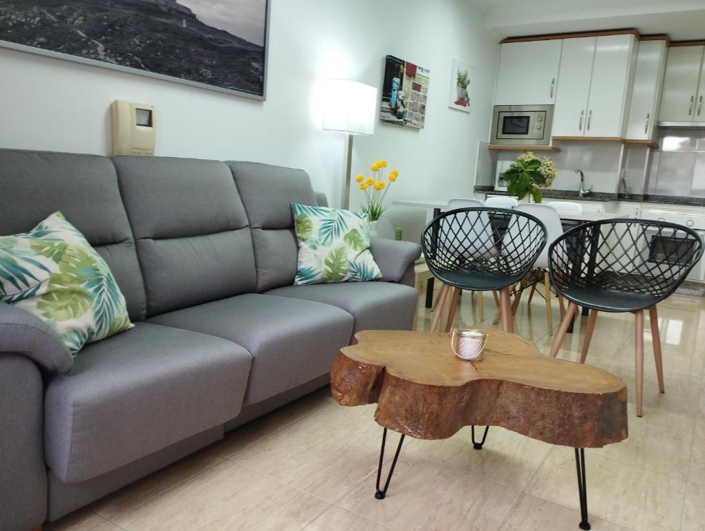 a living room with a couch and a table at Fogar do Vento-Ordes, cerca de Camino Inglés Bruma in Ordes
