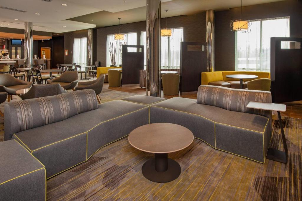 a lobby with a couch and a table and chairs at Courtyard by Marriott Hagerstown in Hagerstown