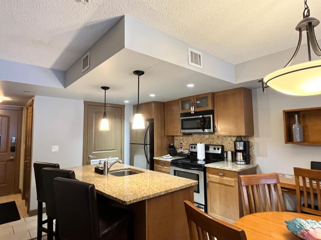 a kitchen with a sink and a counter top at Perfect family 2-bed Condo with hot tub in Dead Man's Flats