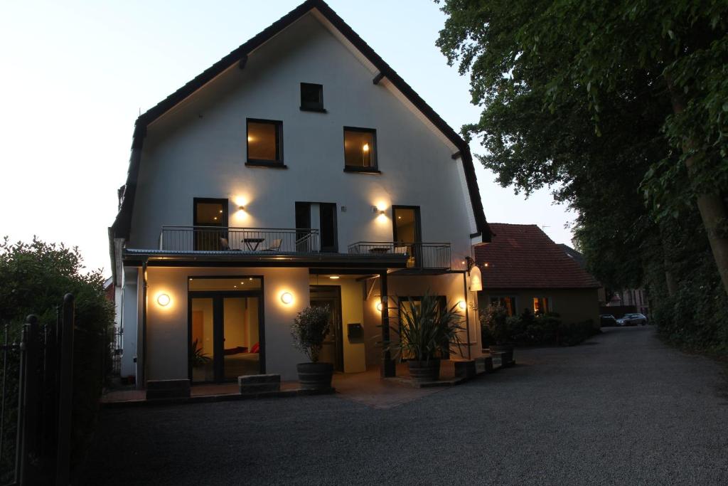 a large white house with windows and a balcony at Nella Parkhotel in Steinhude