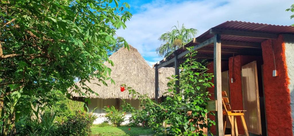 an entrance to a house with a thatch roof at Hostal Zirumake Dentro del Parque Tayrona in El Zaino