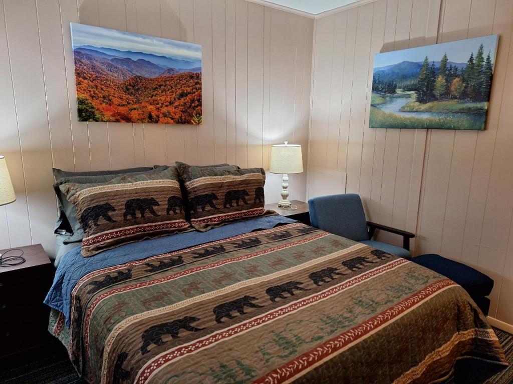 a bedroom with a bed and two paintings on the wall at Rest Stop 6 Inn in Clarendon