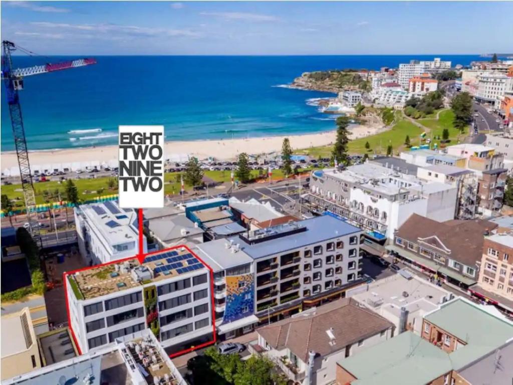 an aerial view of a city with the beach at EIGHT TWO NINE TWO III: BONDI BEACH in Sydney