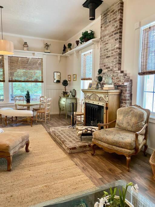 a living room with a fireplace and a table and chairs at The Shopkeeper's Cottage ~ CHIC! in Amador City