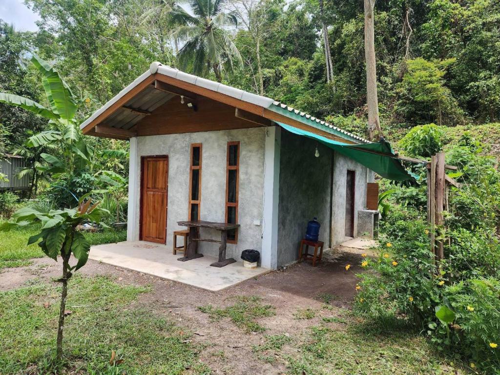 a small house in the middle of a forest at lungpeiykhomestay house in Ban Bang Bao