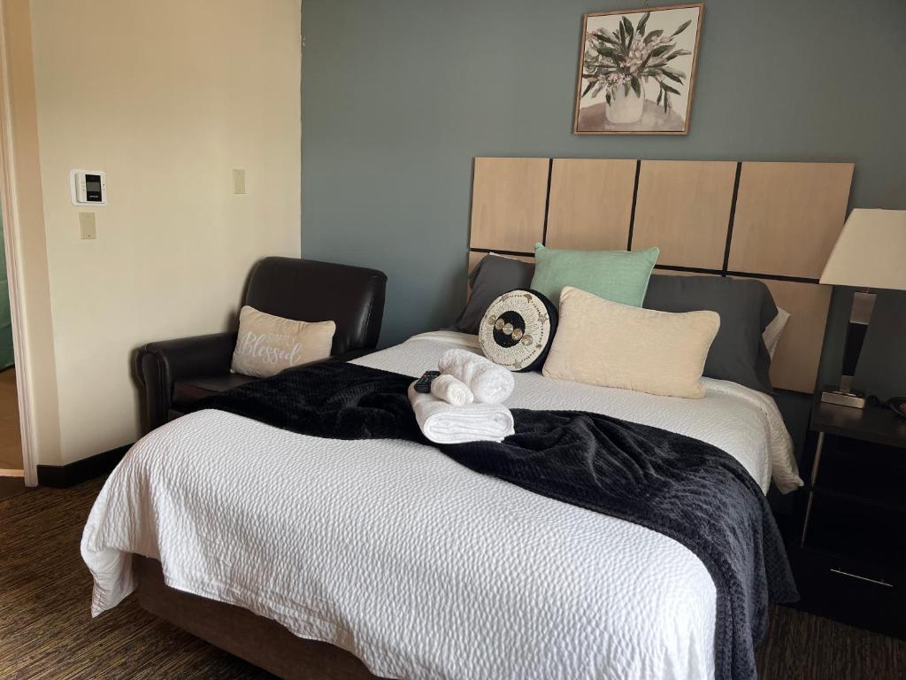 a bedroom with a large bed with two stuffed animals on it at SONESTA in Houston
