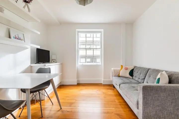 a living room with a couch and a table at London City 1 Bed with Roof Terrace in London