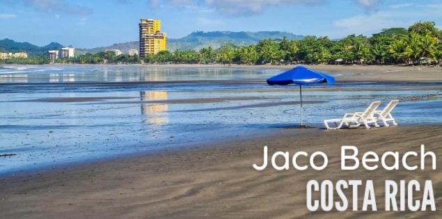 ハコにあるVillas Paraíso Jacó B20のビーチでの椅子2脚とパラソル1本