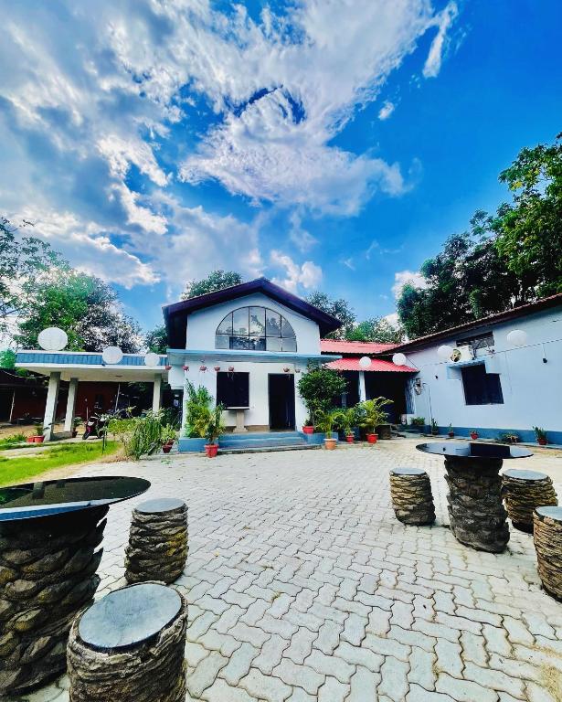 a building with stools in front of a courtyard at Urban Villa in Guwahati