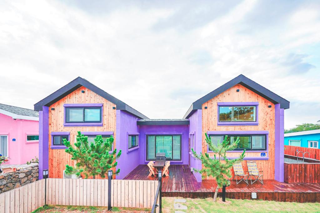 a colorful house with a fence in front of it at Jeju Love Stay Purple in Jeju