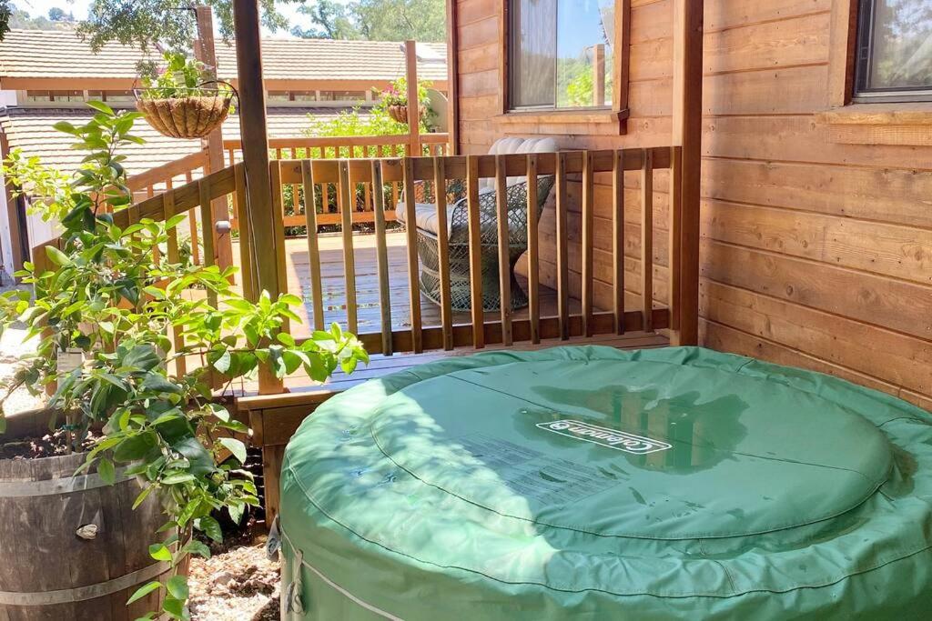 a hot tub sitting on the deck of a cabin at B-B Ranch Cottage~Heart of Gold Country~*HOT TUB* in Pilot Hill